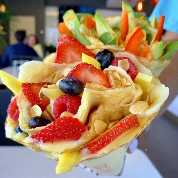 Two Eight Turn Crepes, one sweet with berries and mango, one savory with avocado and carrots.