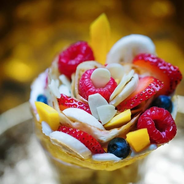 Eight Turn Crepe's fruit crepe, filled with raspberries, strawberries, blueberries, mango, banana, and almonds.